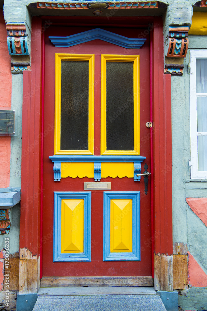 Fototapeta premium Front door with glass windows and painted wooden board