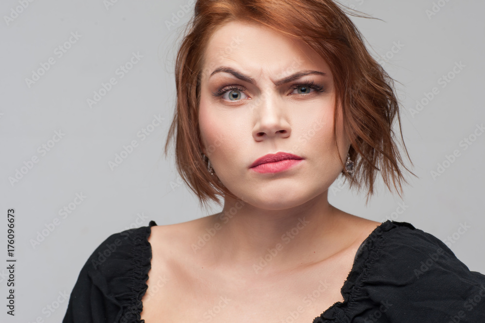 Women jealousy. Suspicion in adultery. Distrust in relationships, grumpy female mood on grey background. Personal life problems, suspicious concept Women jealousy. Suspicion in adultery. Distrust in relationships, grumpy female mood on grey background. Personal life problems, suspicious concept