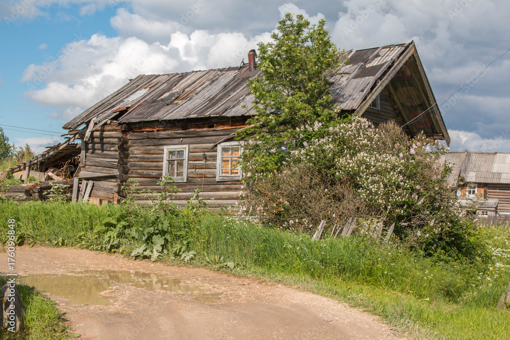 north Russian village Isady. Summer day, Emca river, old cottages on the shore, old wooden bridge. Abandoned building. north Russian village Isady. Summer day, Emca river, old cottages on the shore, old wooden bridge. Abandoned building.