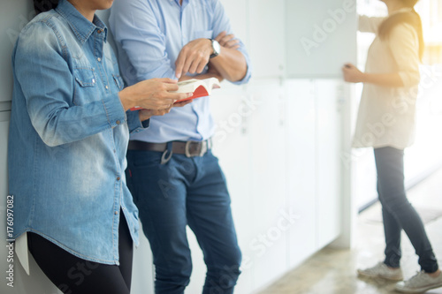 woman and man standing infort of locker line