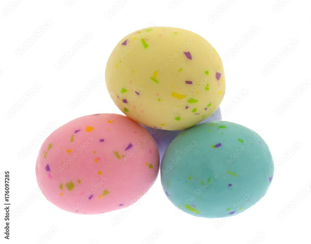 Several speckled Easter egg malt ball candies isolated on a white background.