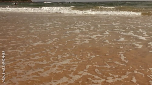 Tropical beach - waves hitting sand; steadicam footage, no people; South China Sea, Guangdong province, China photo