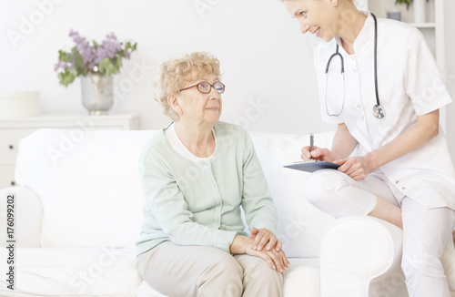 Doctor smiling to elderly patient