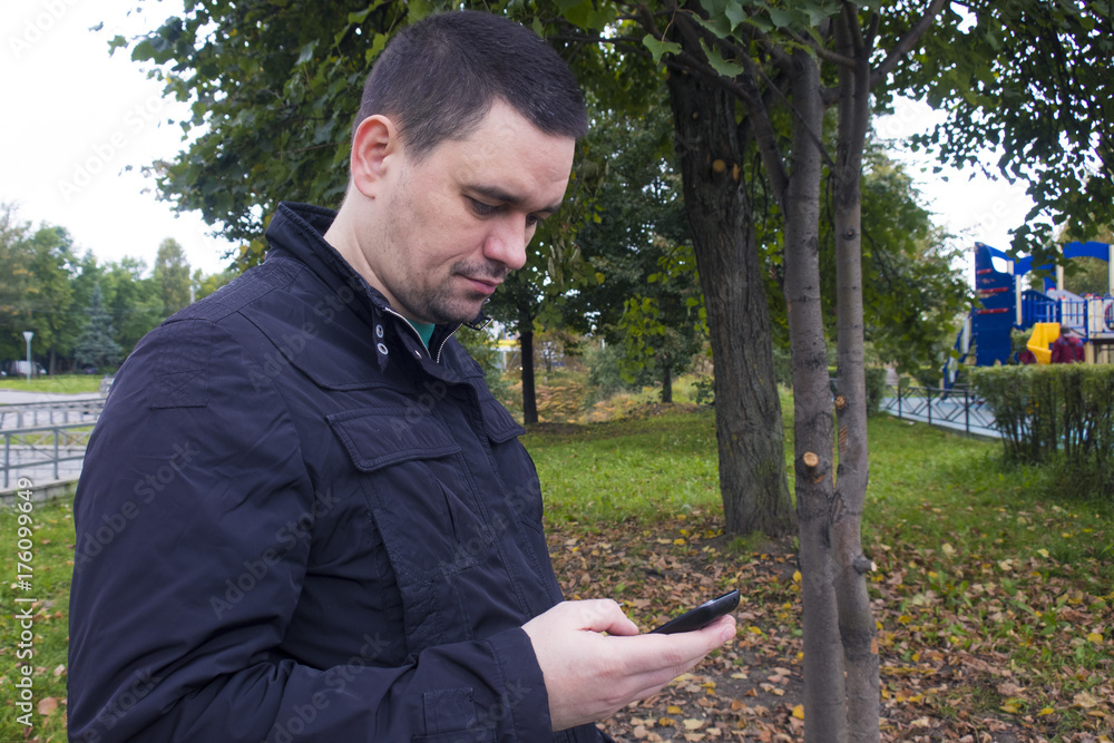 the man looks sadly at the mobile phone the man looks sadly at the mobile phone