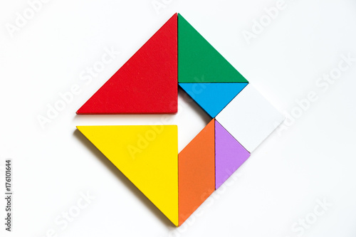 Colorwood tangram puzzle on square with arrow sign shape on white background (Concept of Business direction, company vision or target)