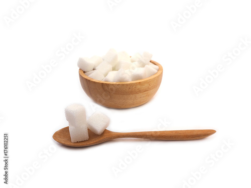Sugar cubes on wooden spoon