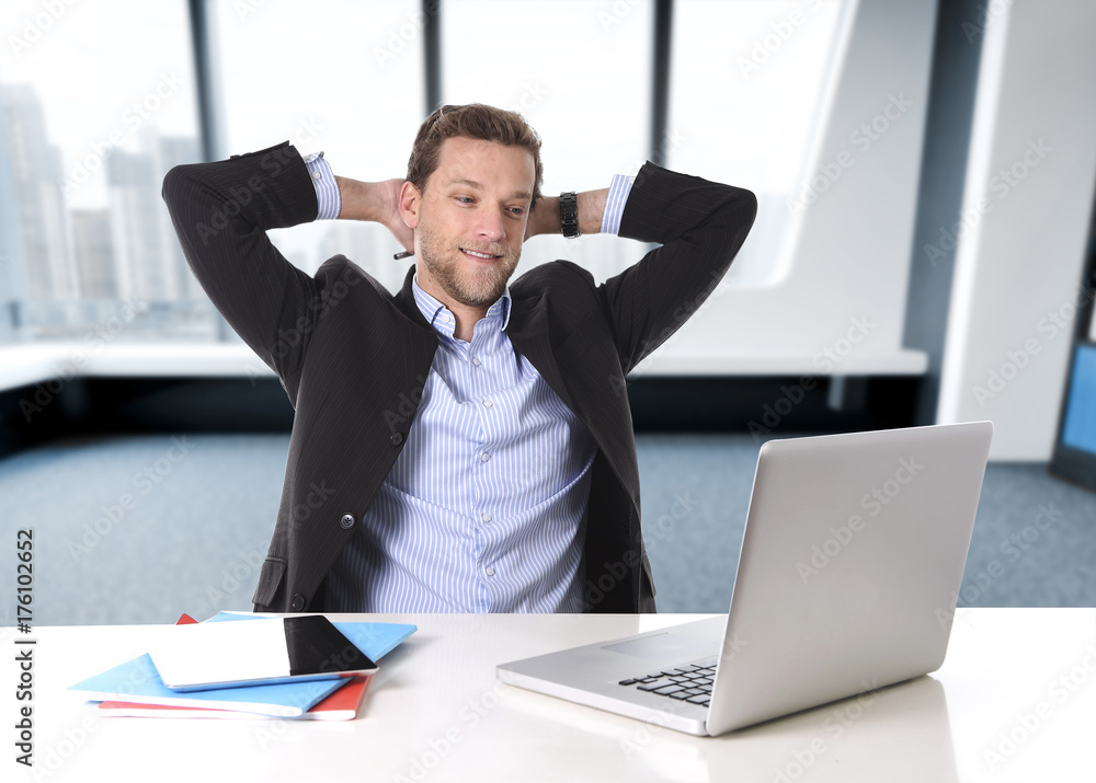 attractive businessman happy at office work sitting at computer desk satisfied and smiling relaxed attractive businessman happy at office work sitting at computer desk satisfied and smiling relaxed