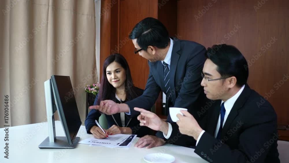 Business team working brainstorming with new business project in front of computer at office. Business team working brainstorming with new business project in front of computer at office.