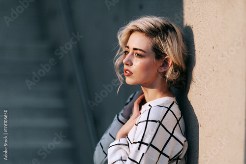 Woman leaning against wall photo