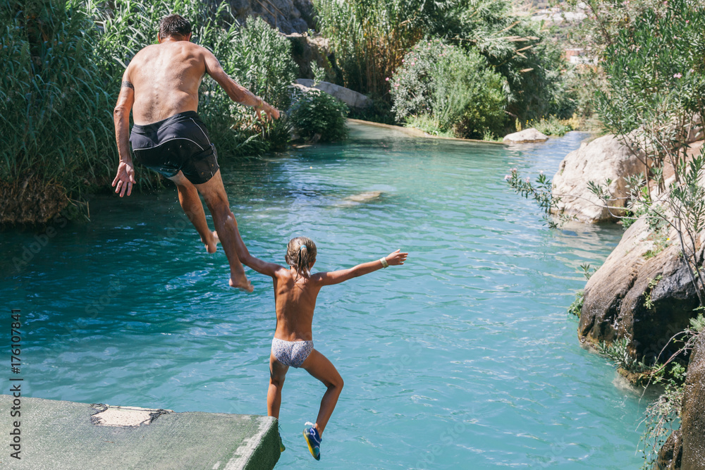 Father and Daughter Jumping into the River Father and Daughter Jumping into the River