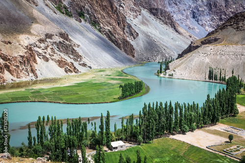 Phander Valley in Pakistan is beautiful landscape with s-curve turquoise river photo