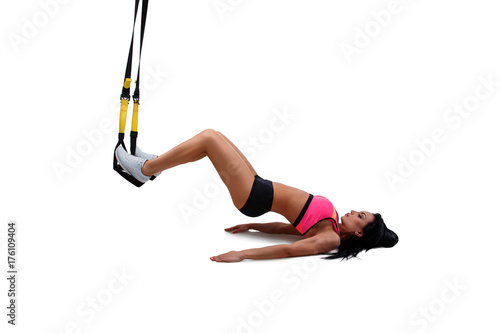 Woman exercising with suspension straps photo