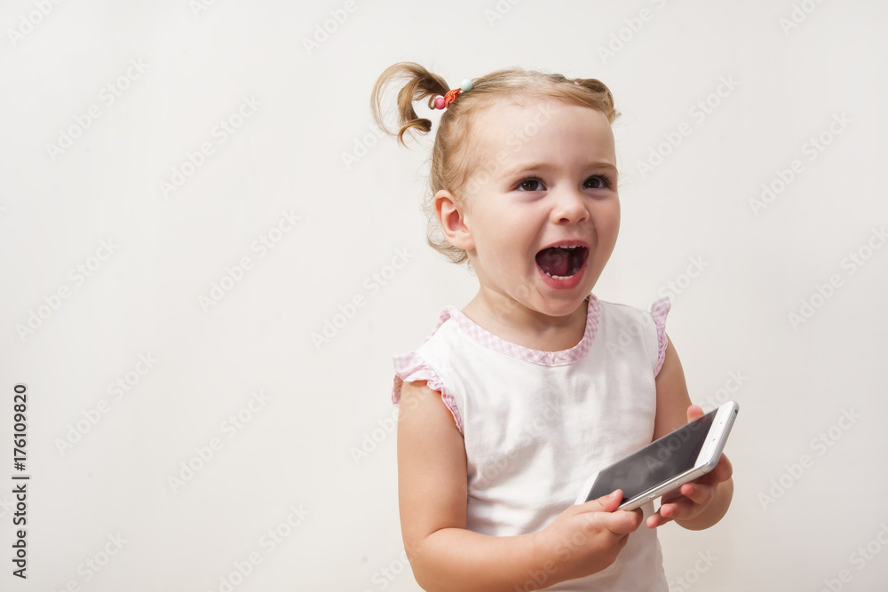 Baby girl playing with a mobile phone Baby girl playing with a mobile phone