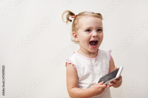 Baby girl playing with a mobile phone