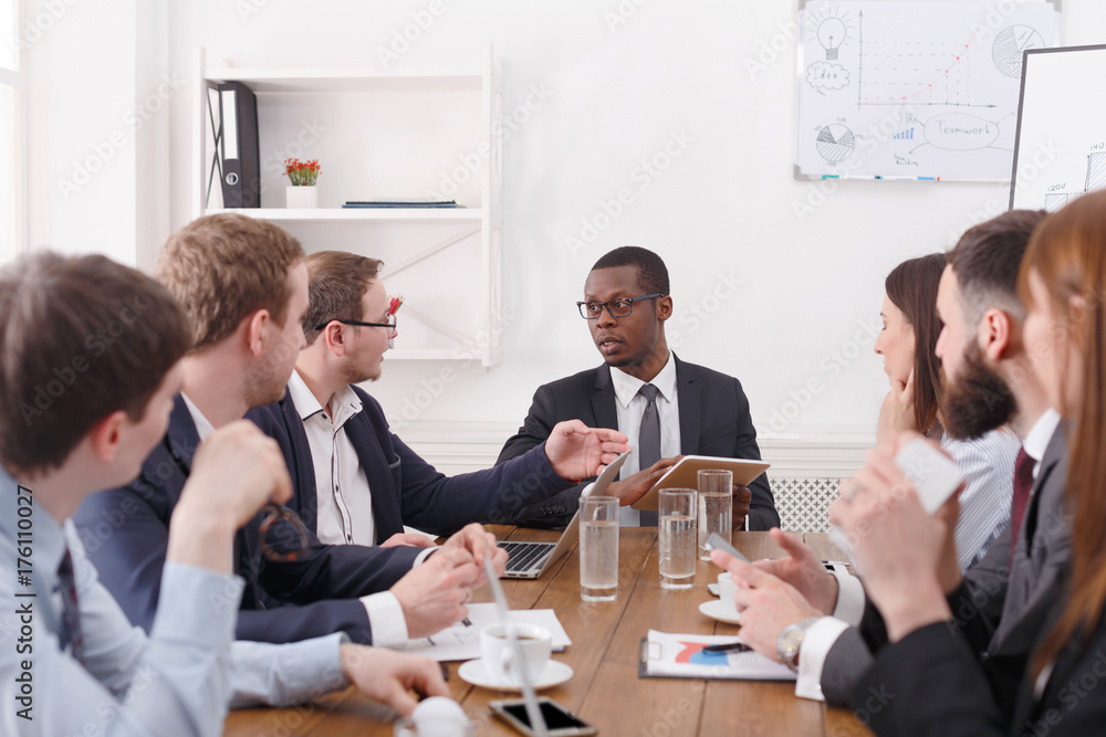 Business team meeting of young successful team with black male boss. Business team meeting of young successful team with black male boss.