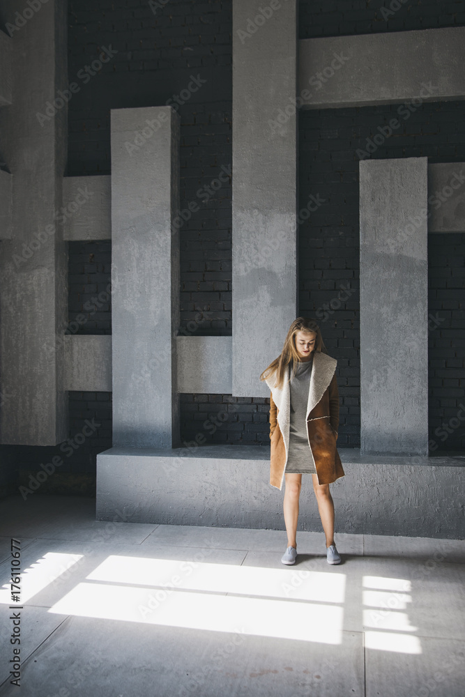 Girl standing in front of abstract wall Girl standing in front of abstract wall