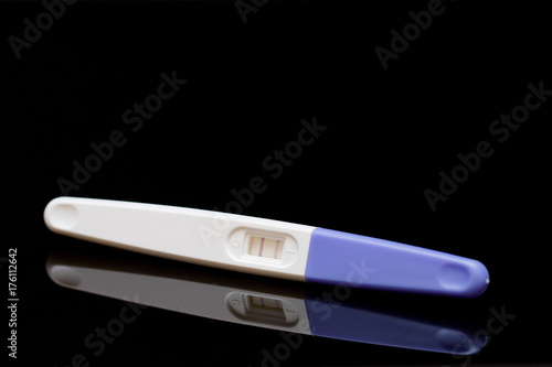 positive pregnancy test on black background