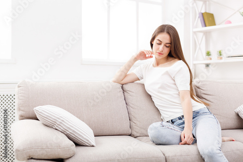 Pensive young woman at home