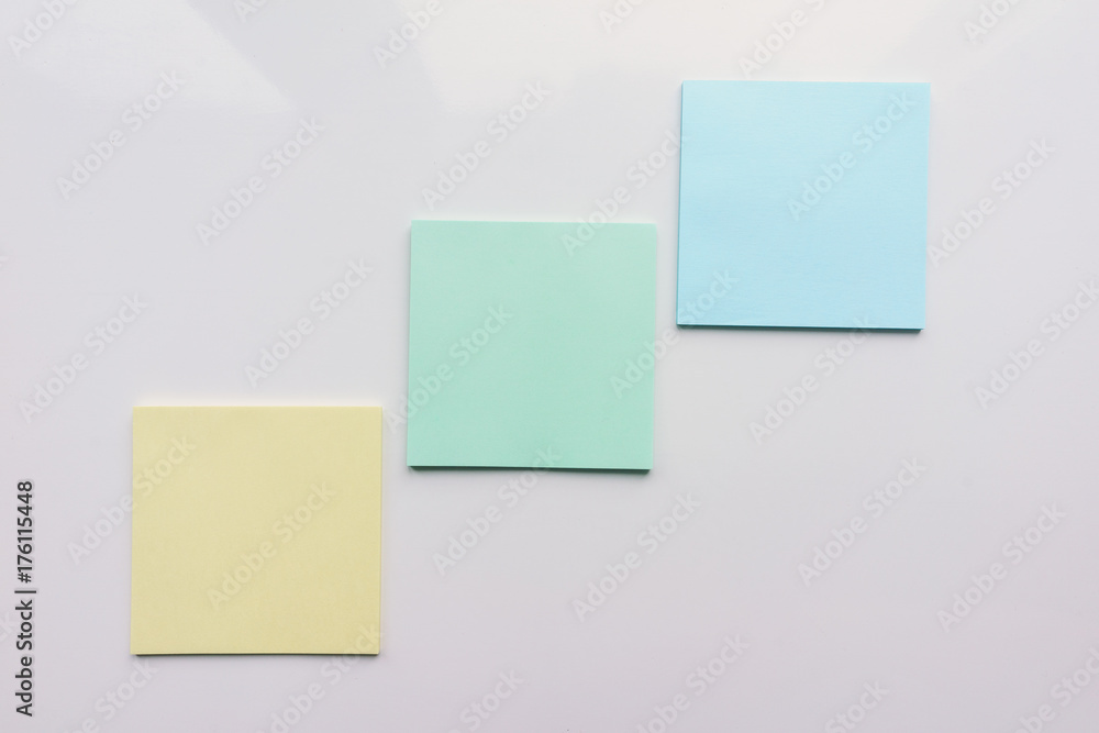 Three square sheet on a white background. Top view. Close-up Three square sheet on a white background. Top view. Close-up