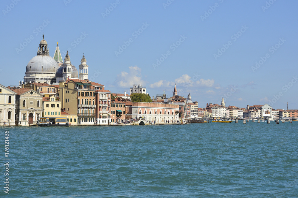 A view of the island of Dorsodoro in Venice taken from the island of Giudecca across the Giudecca Canal. Santa Maria Della Salute can be seen towering above the other buildings
