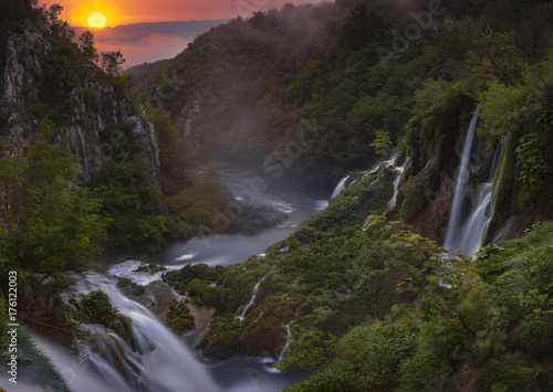 foggy and multicolored dawn over beautiful waterfalls in the park of plitvice lakes in croatia © Mike Mareen