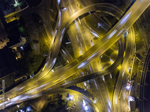 Traffic on freeway interchange. Aerial night view city traffic.