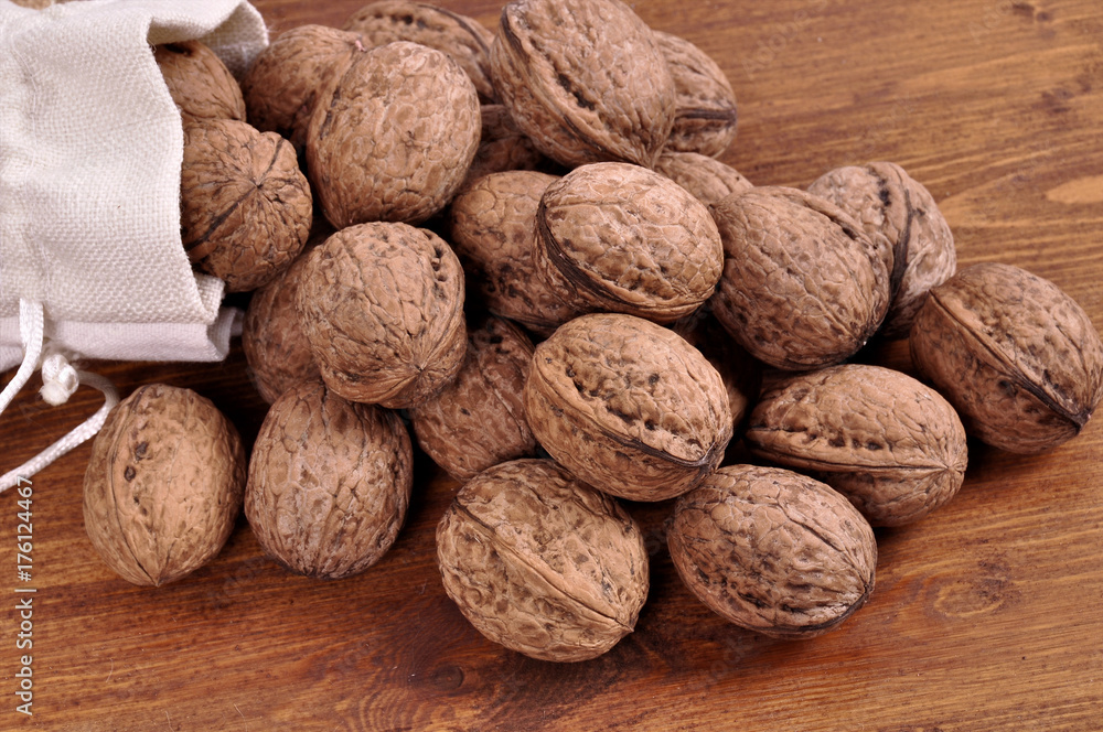 walnuts in wooden plates on a wooden background walnuts in wooden plates on a wooden background