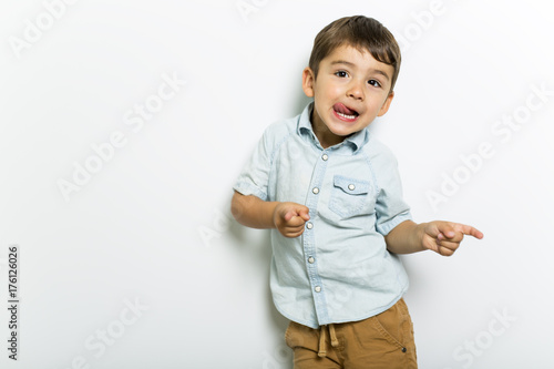 Boy having fun on studio grey background