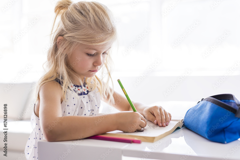 little girl drawing in the kitchen table little girl drawing in the kitchen table