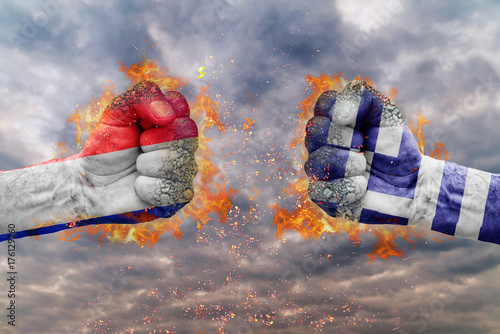 Two fist with the flag of France and Greece each other ready for fight photo