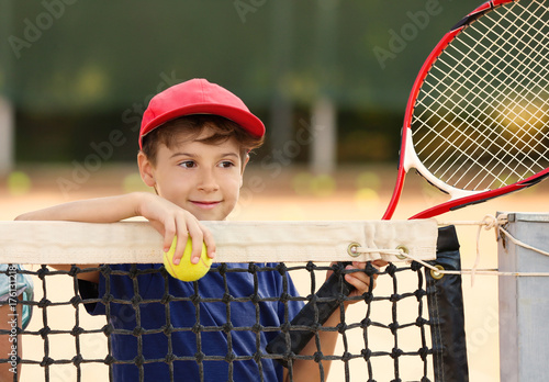 Cute little boy with tennis...