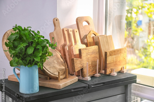 Different wooden boards on table near window in kitchen