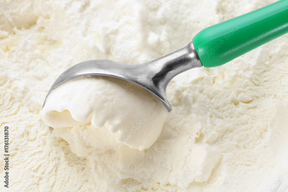 Scoop with delicious vanilla ice cream, closeup Scoop with delicious vanilla ice cream, closeup