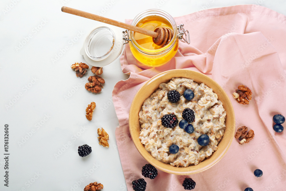 Tasty oatmeal with berries for breakfast on white background Tasty oatmeal with berries for breakfast on white background