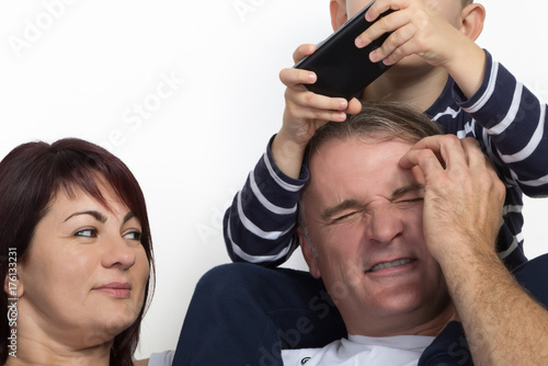 Cropped image of a family with mother, father and on a mobile phone playing son