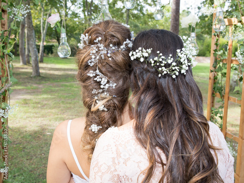 two girl with flowers in head for spring in wedding day, one is witness and bride