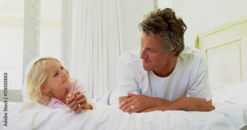 Father and daughter lying together in bedroom Father and daughter lying together in bedroom