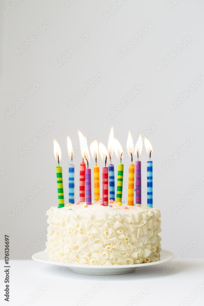 Birthday cake with colorful candles against white background Stock ...