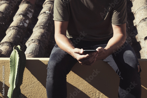 young man using a smartphone in the street