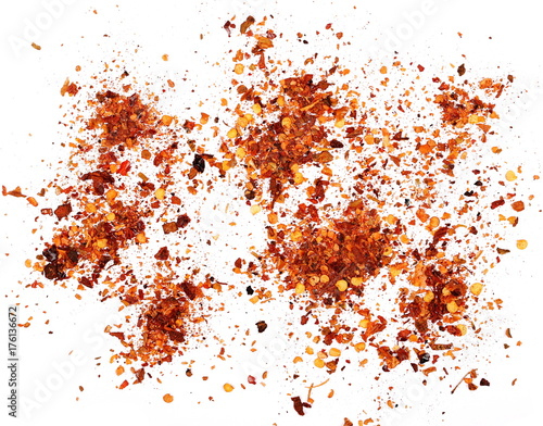 pile crushed red cayenne pepper, dried chili flakes and seeds isolated on white background
