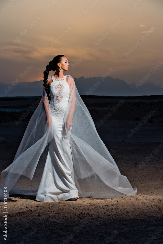 Bride in sand dunes on mountain landscape Bride in sand dunes on mountain landscape
