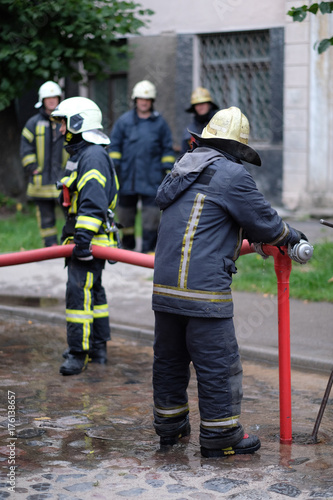Members of the fire brigade at the hydrant of water supply © Anna Jurkovska