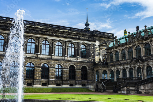 Big architecture building on townsquare in Germany. View under blue sky.