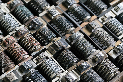 Close up background of vintage metal numbering inserts for printer, diagonal