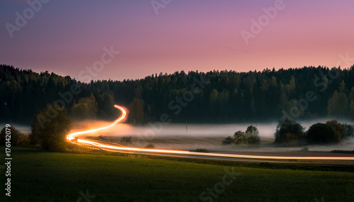 Light trails through the fog photo