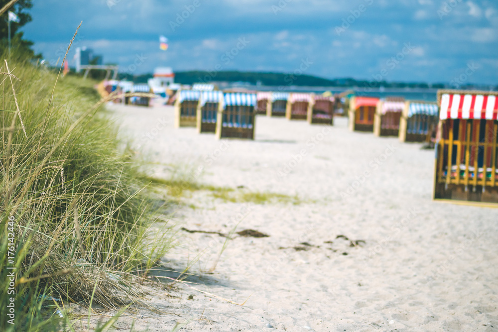 Colorful roofed chairs on sandy beach in Travemunde. Germany