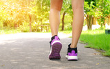 Women wearing fitness shoes are running on park roads.