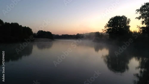 Aerial photography of the river at dawn. Rising mist from the river against the background of the rising sun photo