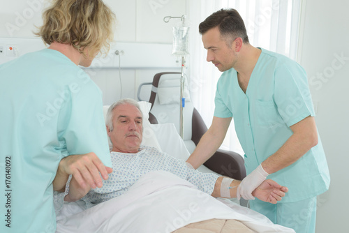 doctor helping a senior patient on bed