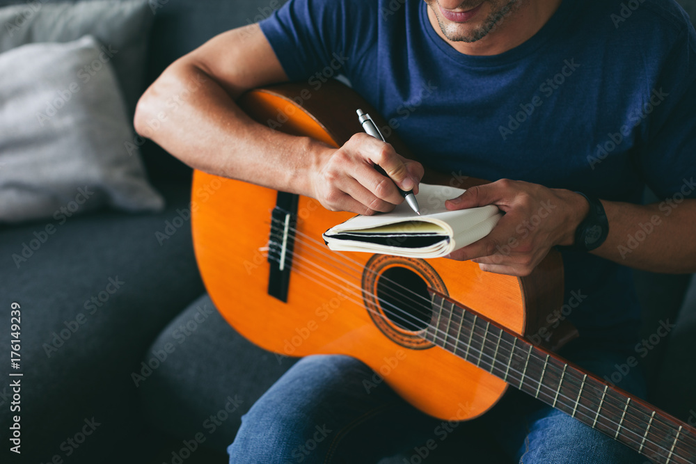 Man composing music with guitar
